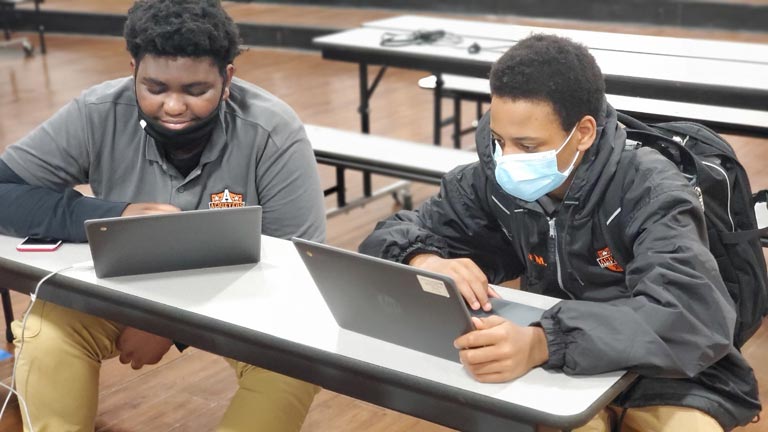 Two students working on laptops